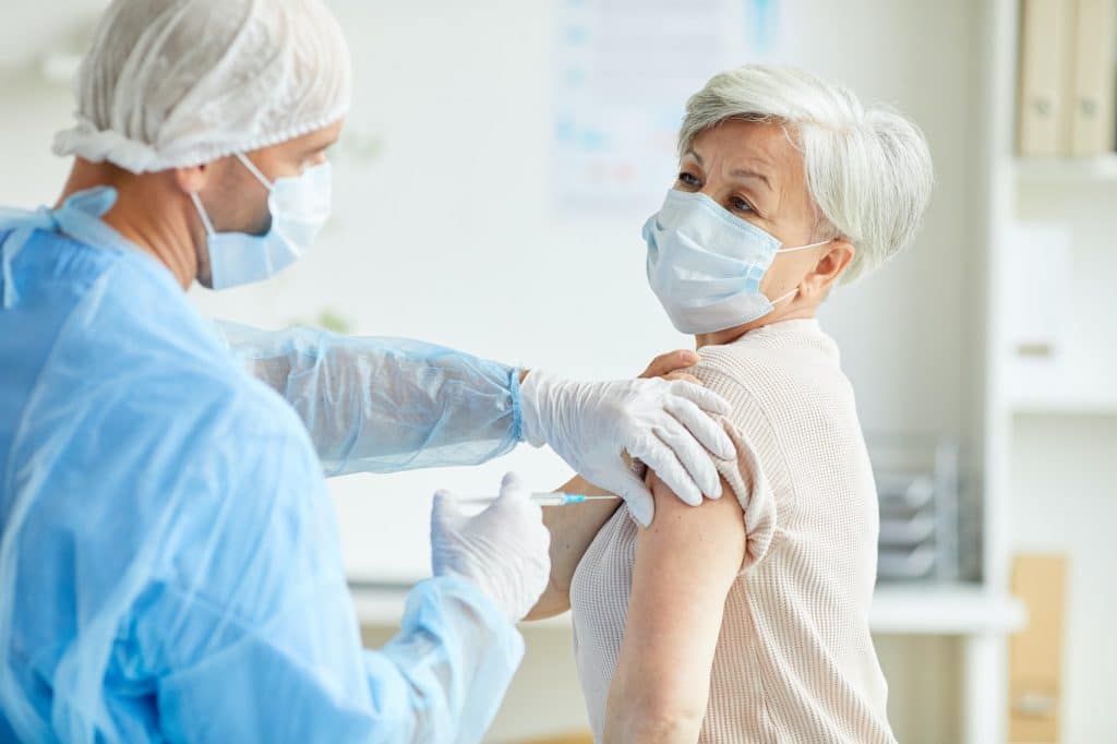 Doctor Giving Covid-19 Vaccine To Woman