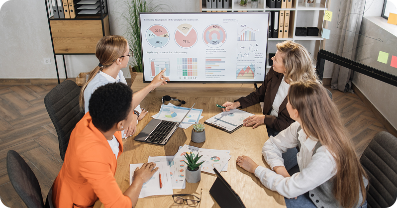 group-of-multiracial-female-financial-analysts-sit
