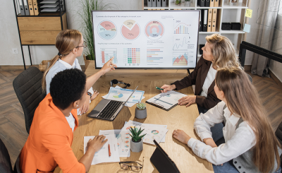 group-of-multiracial-female-financial-analysts-sit