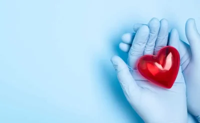 Image of hands holding a red class heart